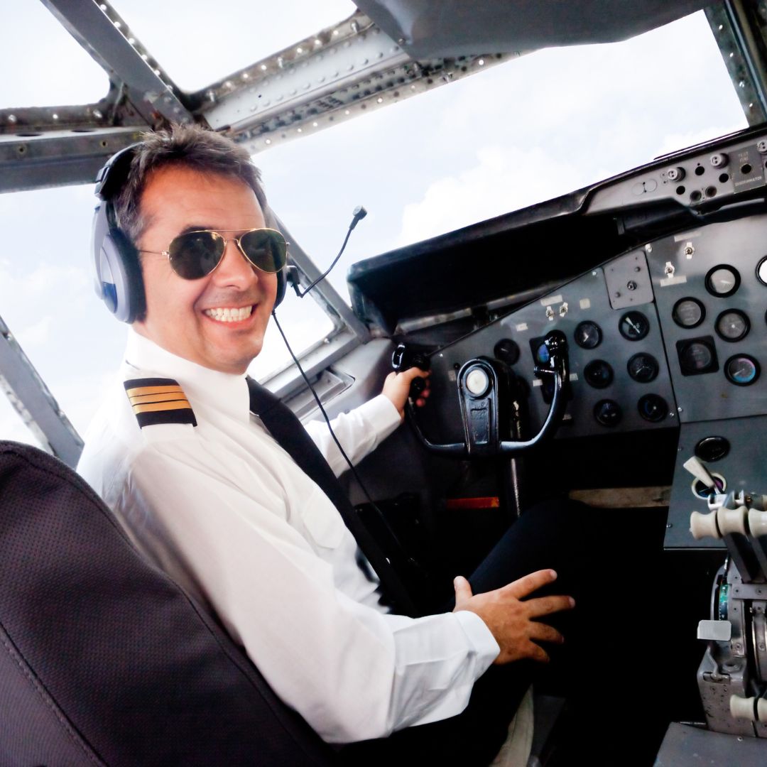 Pilot in cockpit smiling