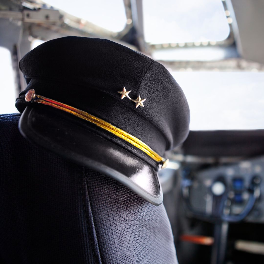 Pilot hat resting on seat in cockpit