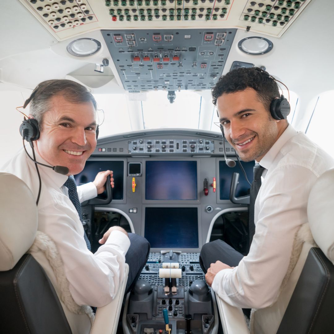 6 smilining airline pilots in cockpit