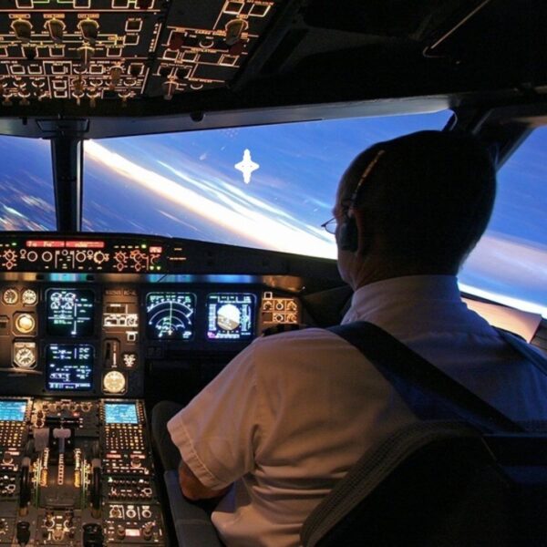 Pilot in cockpit flying an airplane