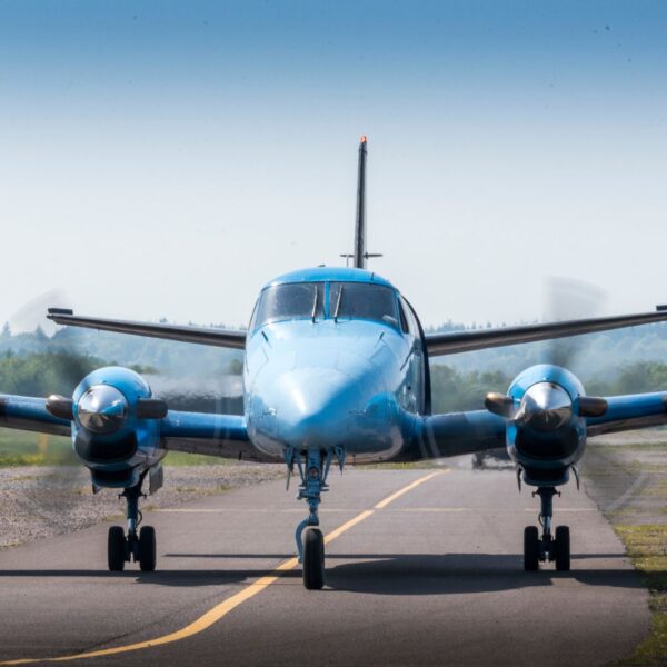 multi-prop plane taxiing on a runway
