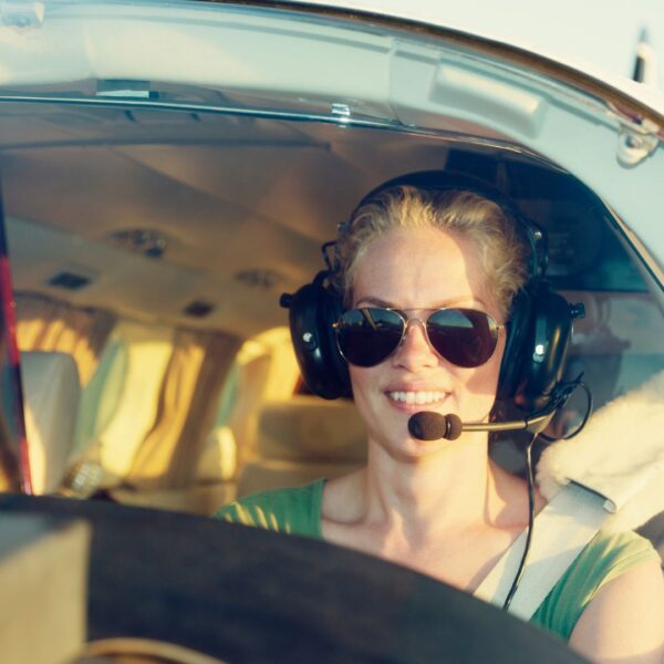 Pilot smiling while flying a small plane