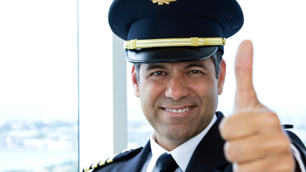 smiling airline pilot with thumbs up