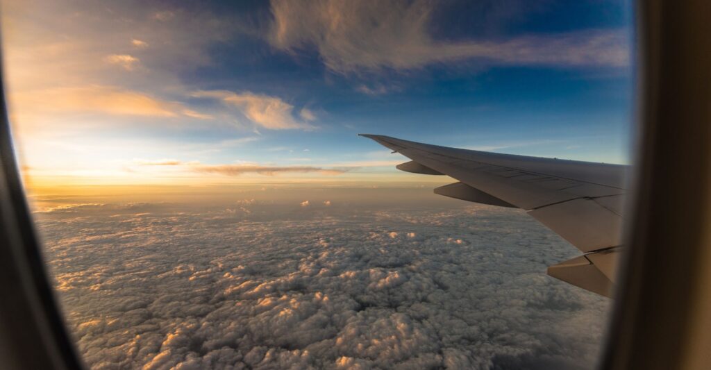 view above clouds from airplane window