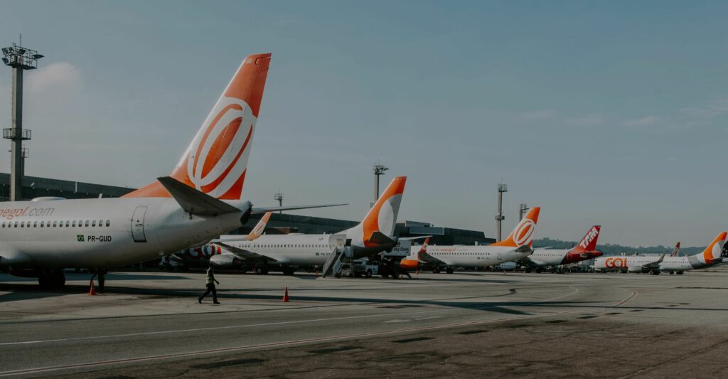 parked commercial planes at airport terminals