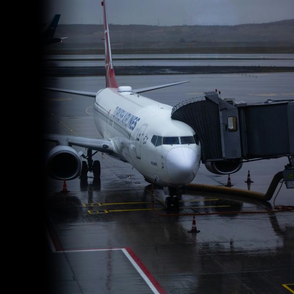 commercial plane loading passengers at the terminal