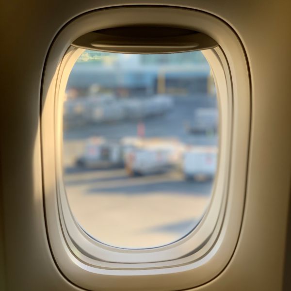 looking out the window of a commercial plane